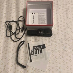 Orange theory tracker. Model - Otbeat burn. Comes w/ charger + extra wristband.